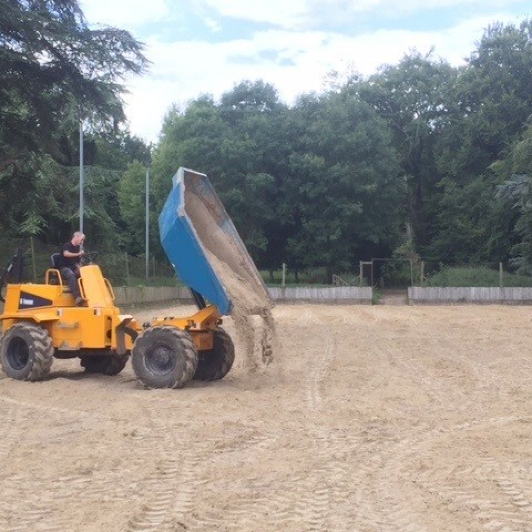 1sttopups A dump truck adding fresh material to an equestrian surface